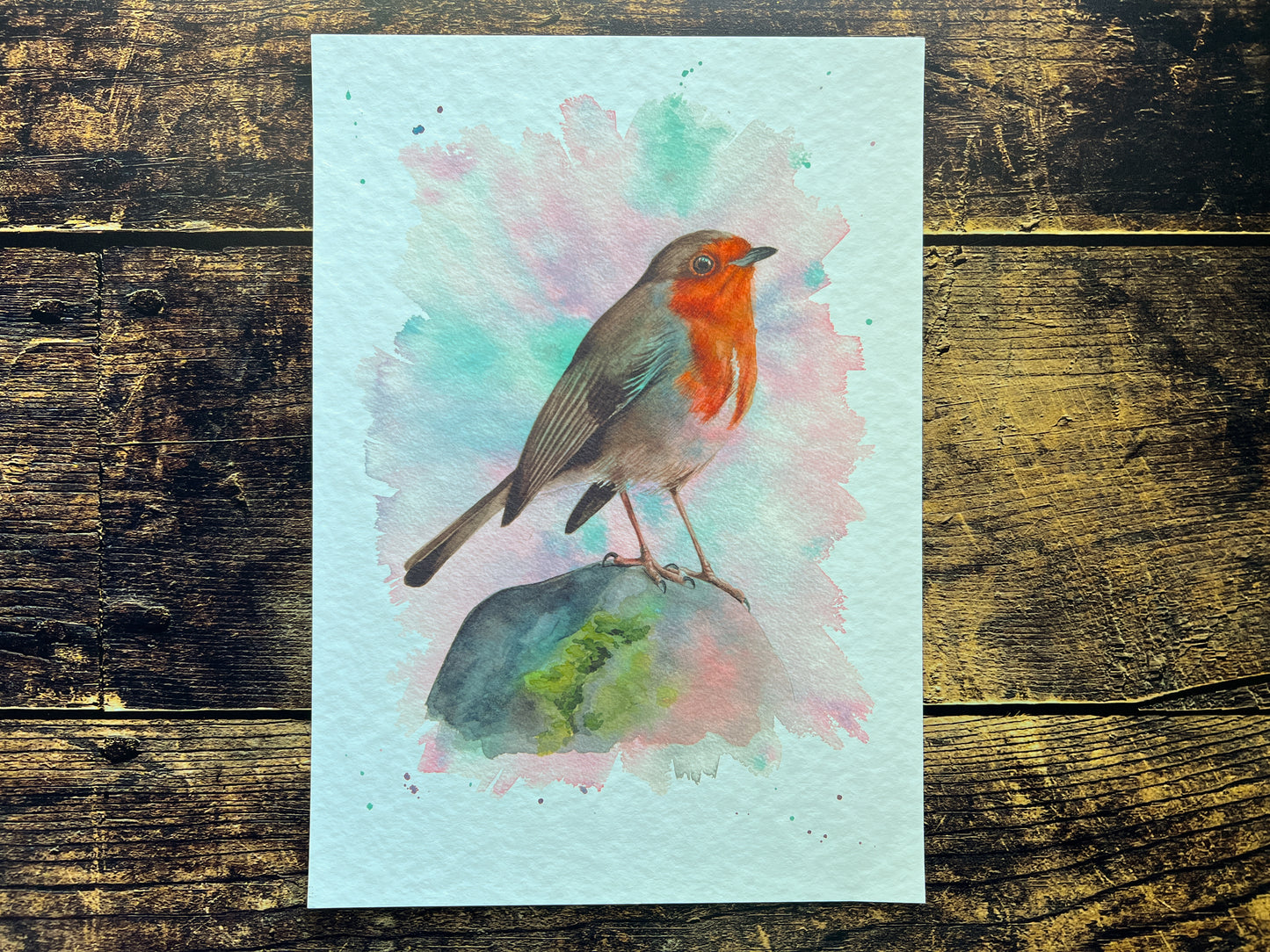 A watercolour print of a robin surrounded by spring colours