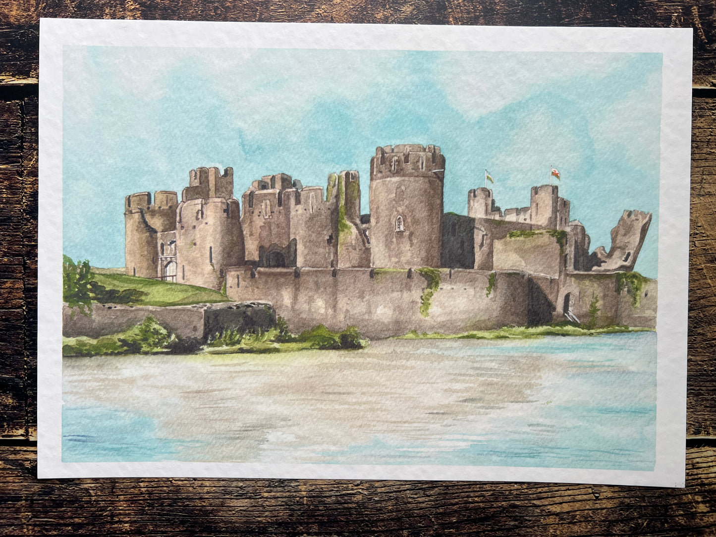 A photograph of a watercolour print depicting Caerphilly castle