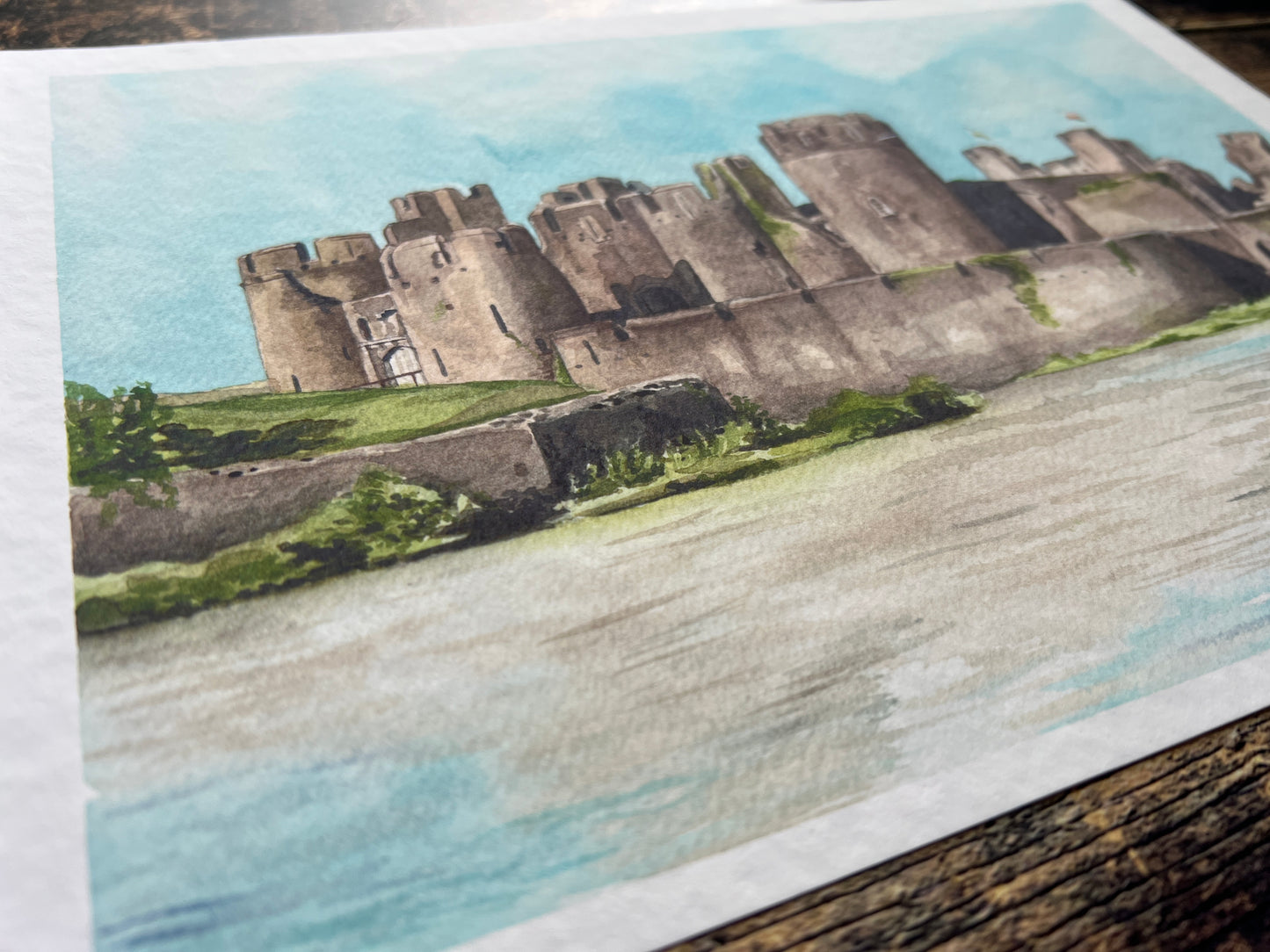 A photograph of a watercolour print depicting Caerphilly castle