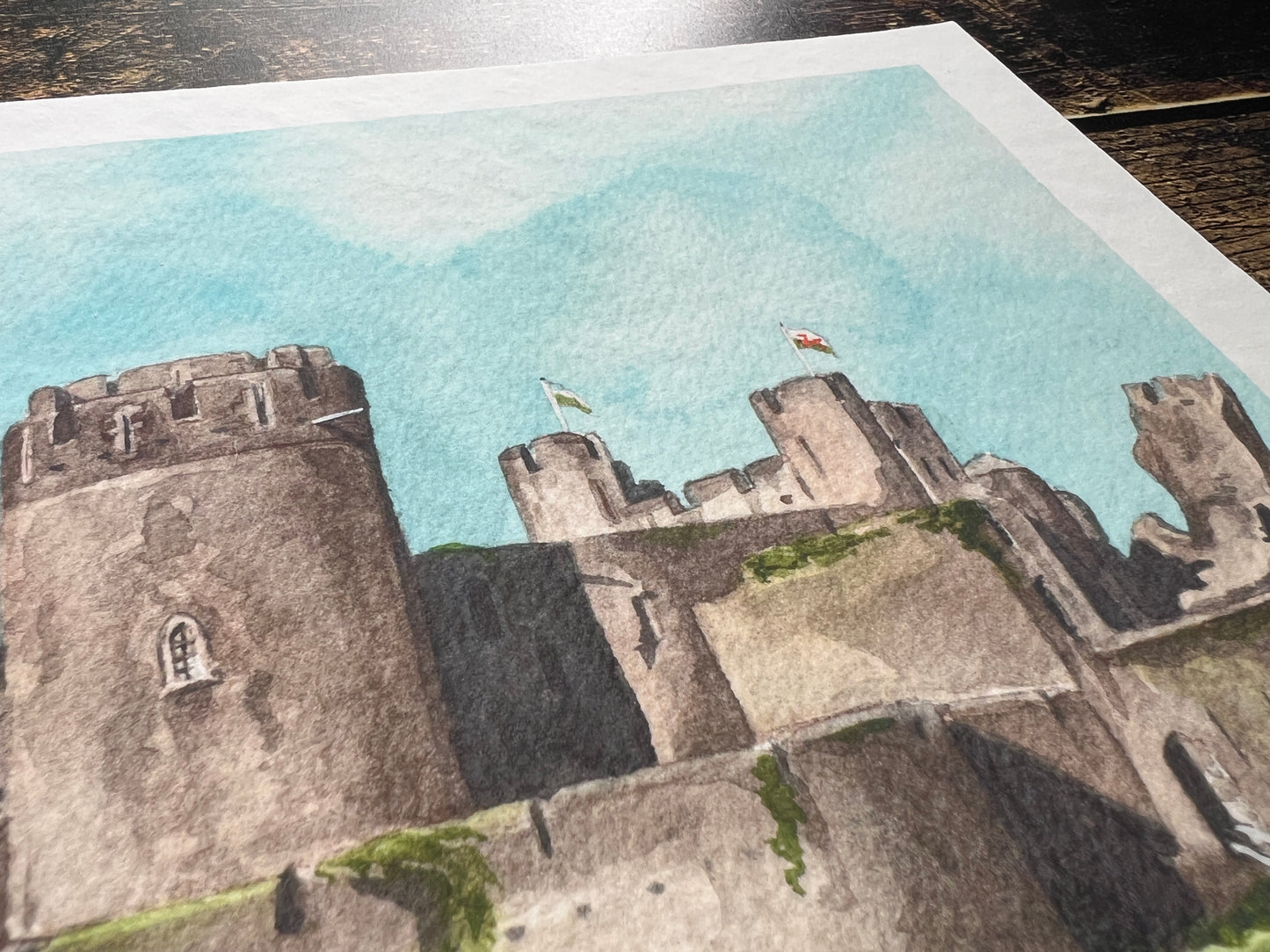 A photograph of a watercolour print depicting Caerphilly castle