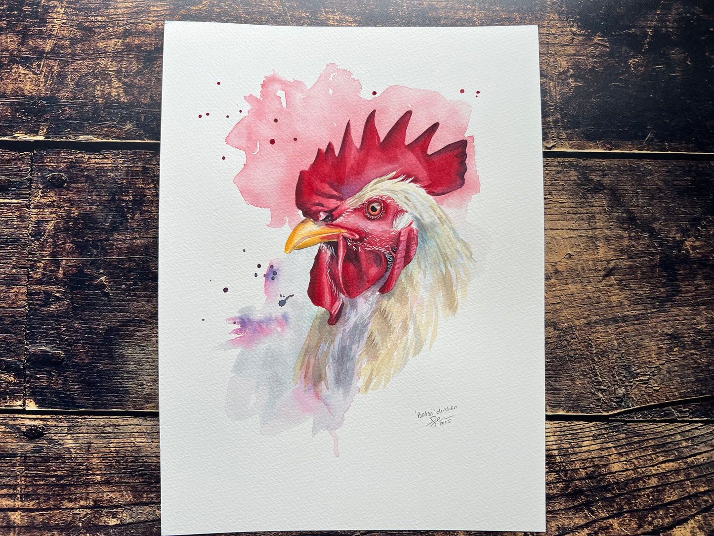 Watercolor painting of a rooster on a wooden surface
