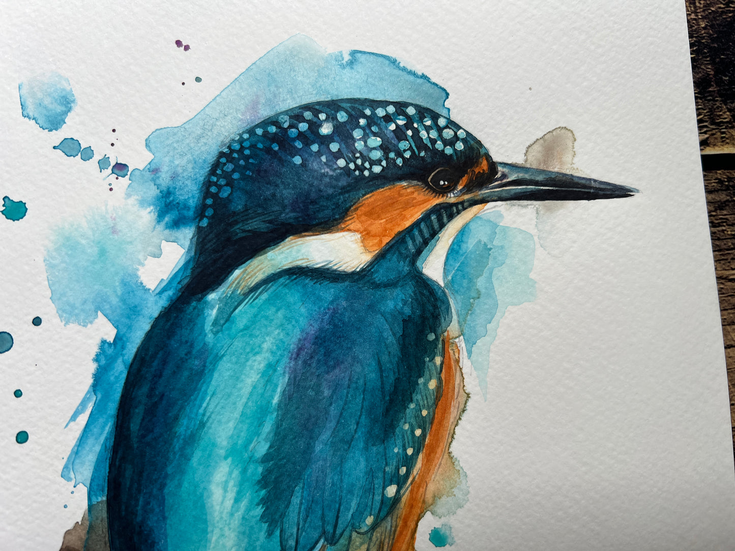 An expressive watercolour painting of a common kingfisher.