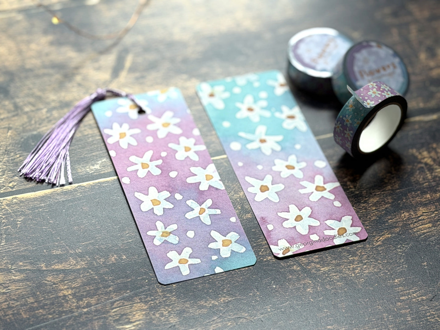 A photo of watercolour floral bookmarks on a wooden background