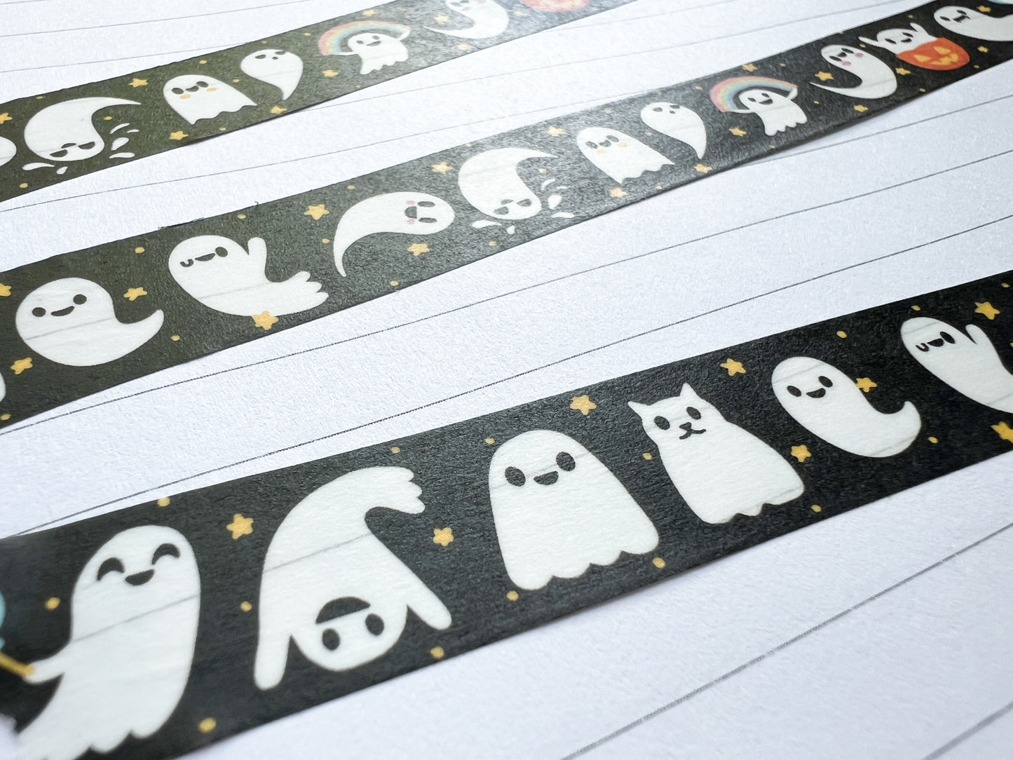 Decorative washi tape with ghost design, stuck in a journal