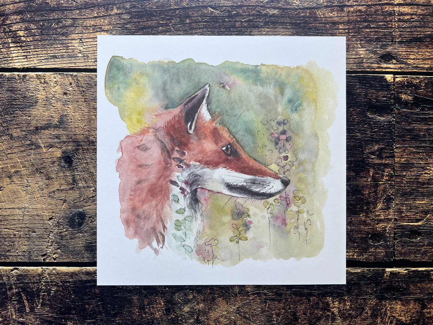 Watercolor painting of a fox on a wooden surface