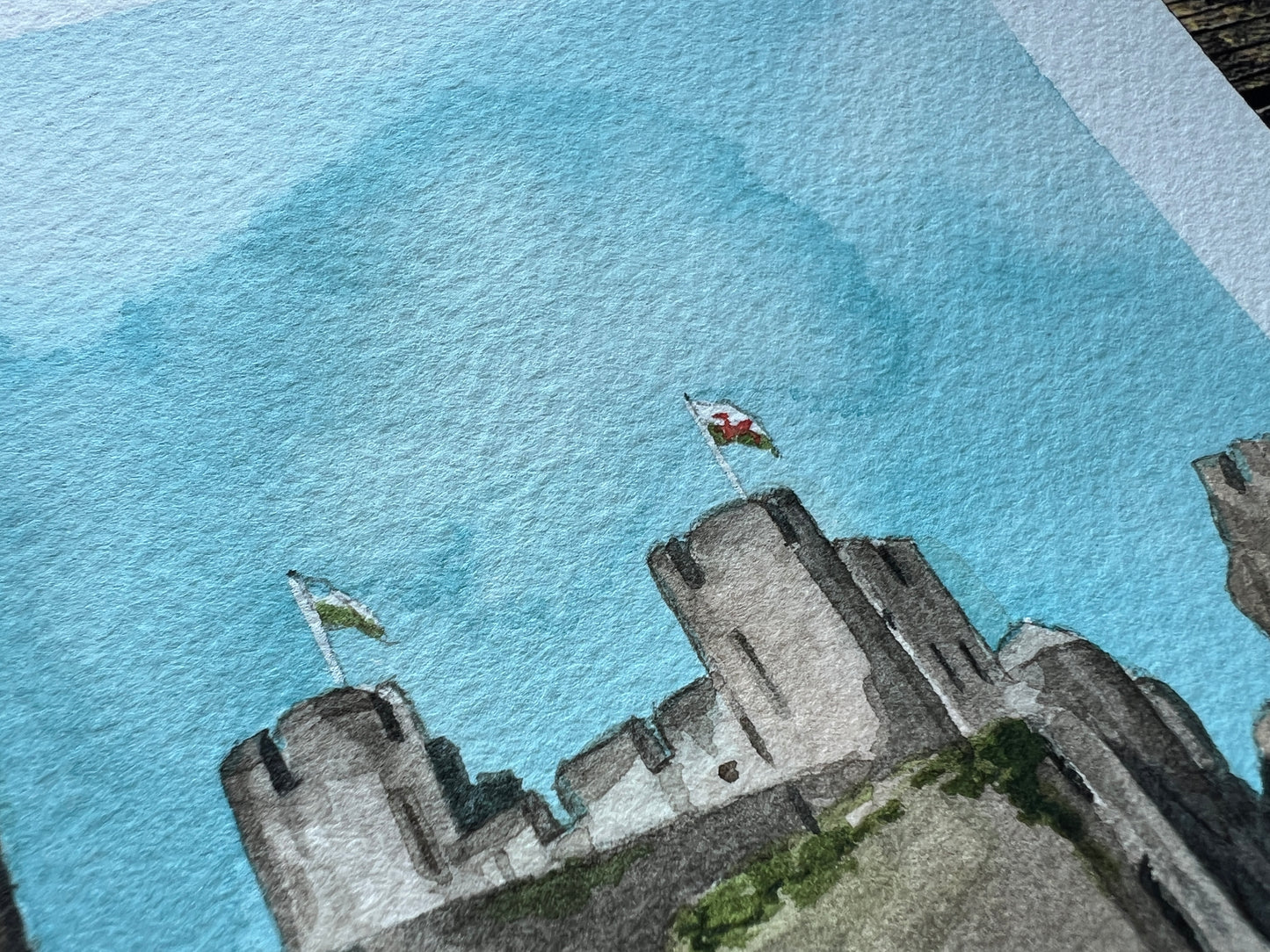 A close up of an original painting of Caerphilly Castle