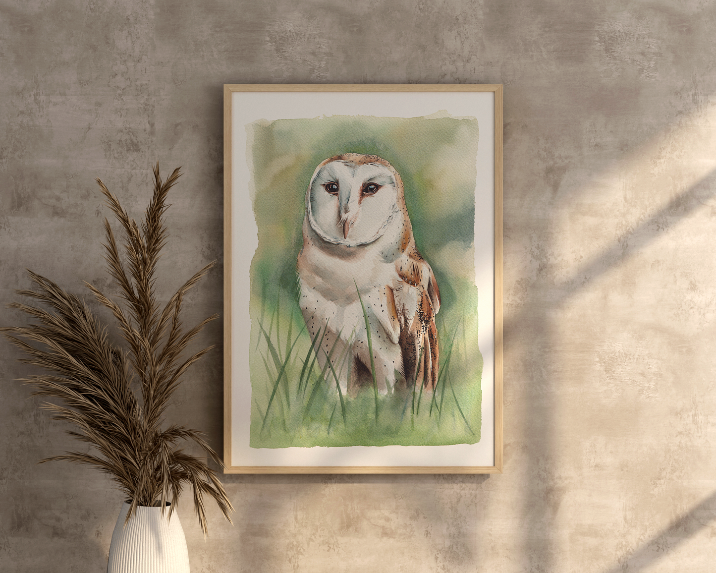 A watercolour print of a barn owl, standing in long grass (so surrounded by green granulated watercolours)