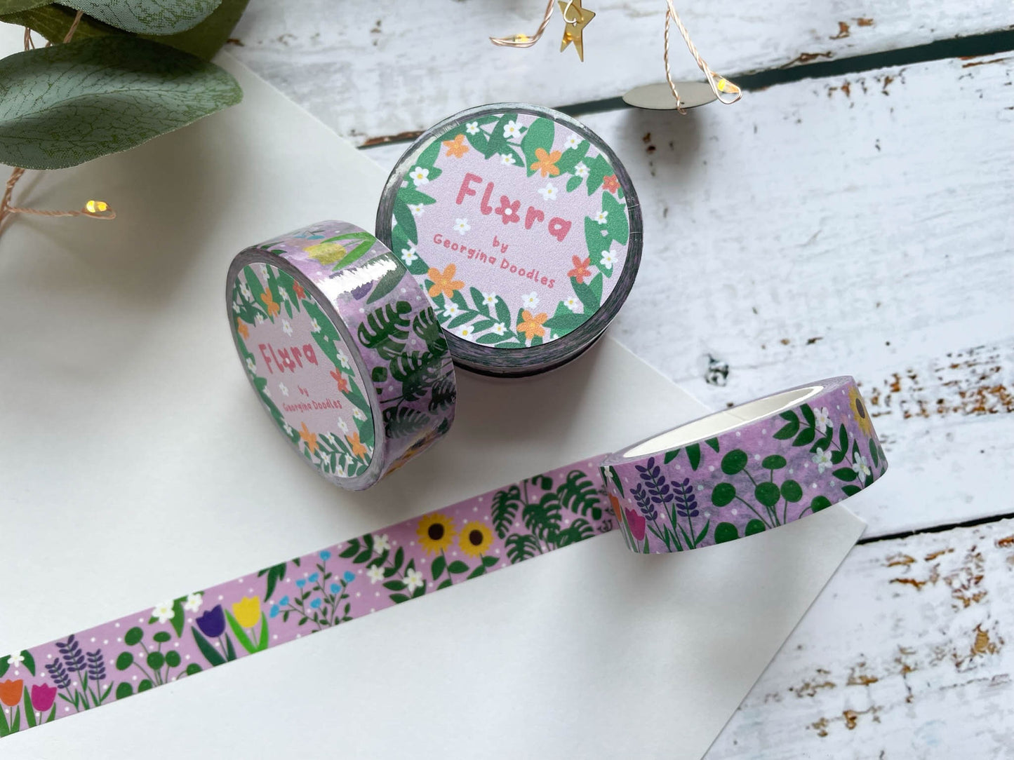 A close up of washi tape with a pink background and covered in flowers