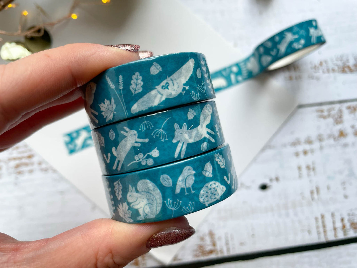 A blue/teal coloured washi tape with white woodland illustrated animals on