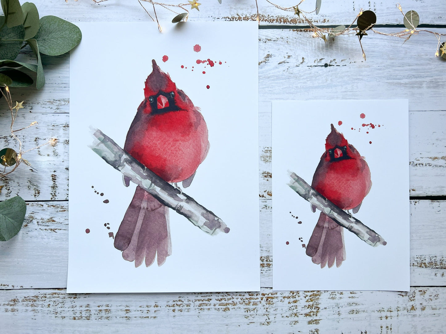 A print of a watercolour painting of a cardinal looking straight at you