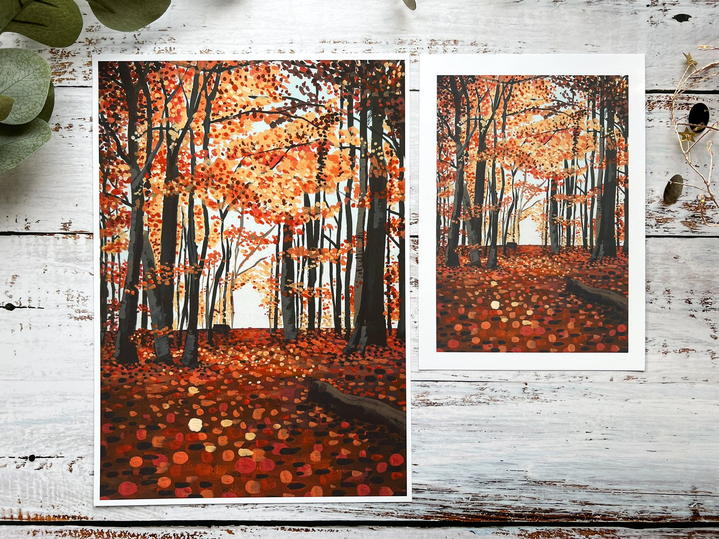 A gouache print of an autumn woodland scene with a slightly abstract ground