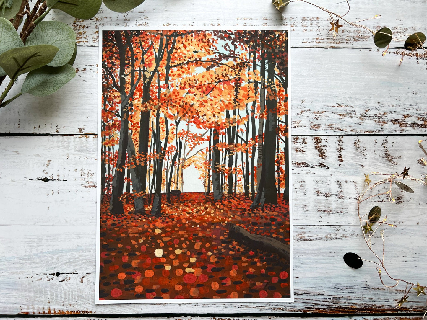 A gouache print of an autumn woodland scene with a slightly abstract ground