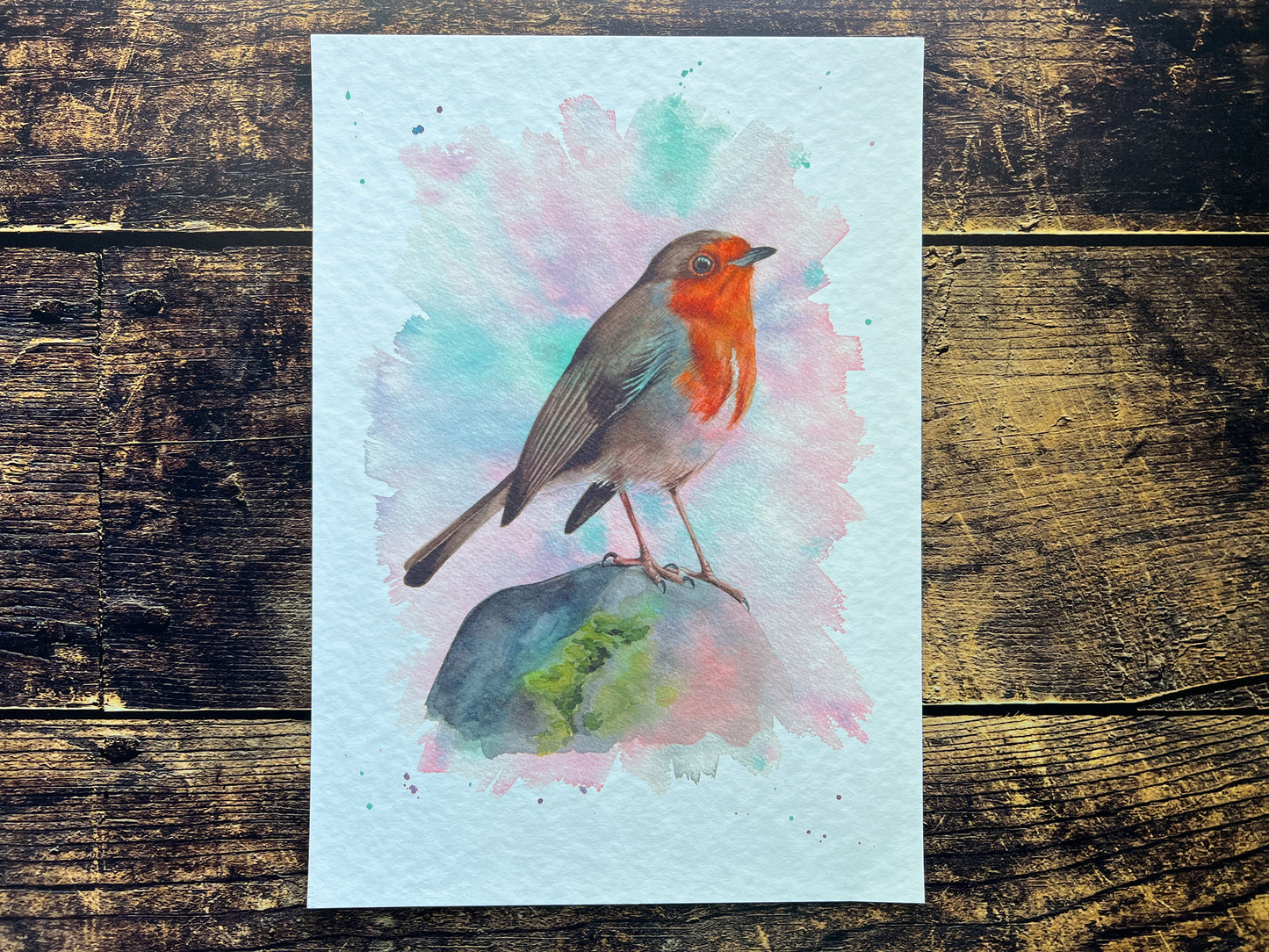A watercolour print of a robin surrounded by Spring colours