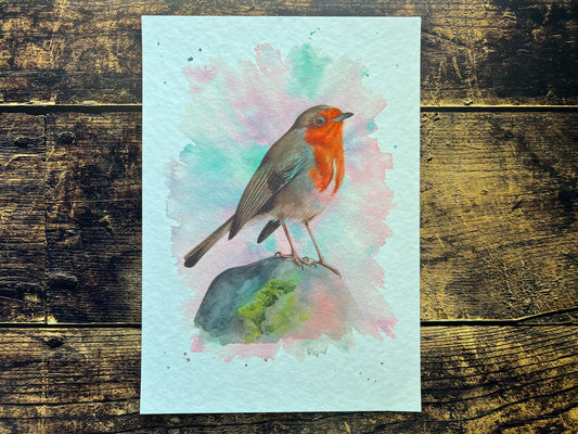 A watercolour print of a robin surrounded by spring colours