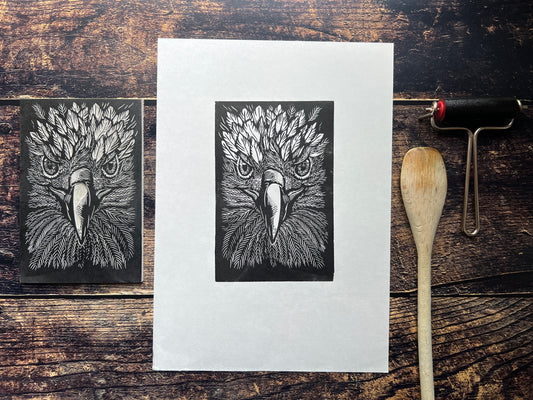 This is a photo of an A4 lino print featuring a close up of a golden eagle.