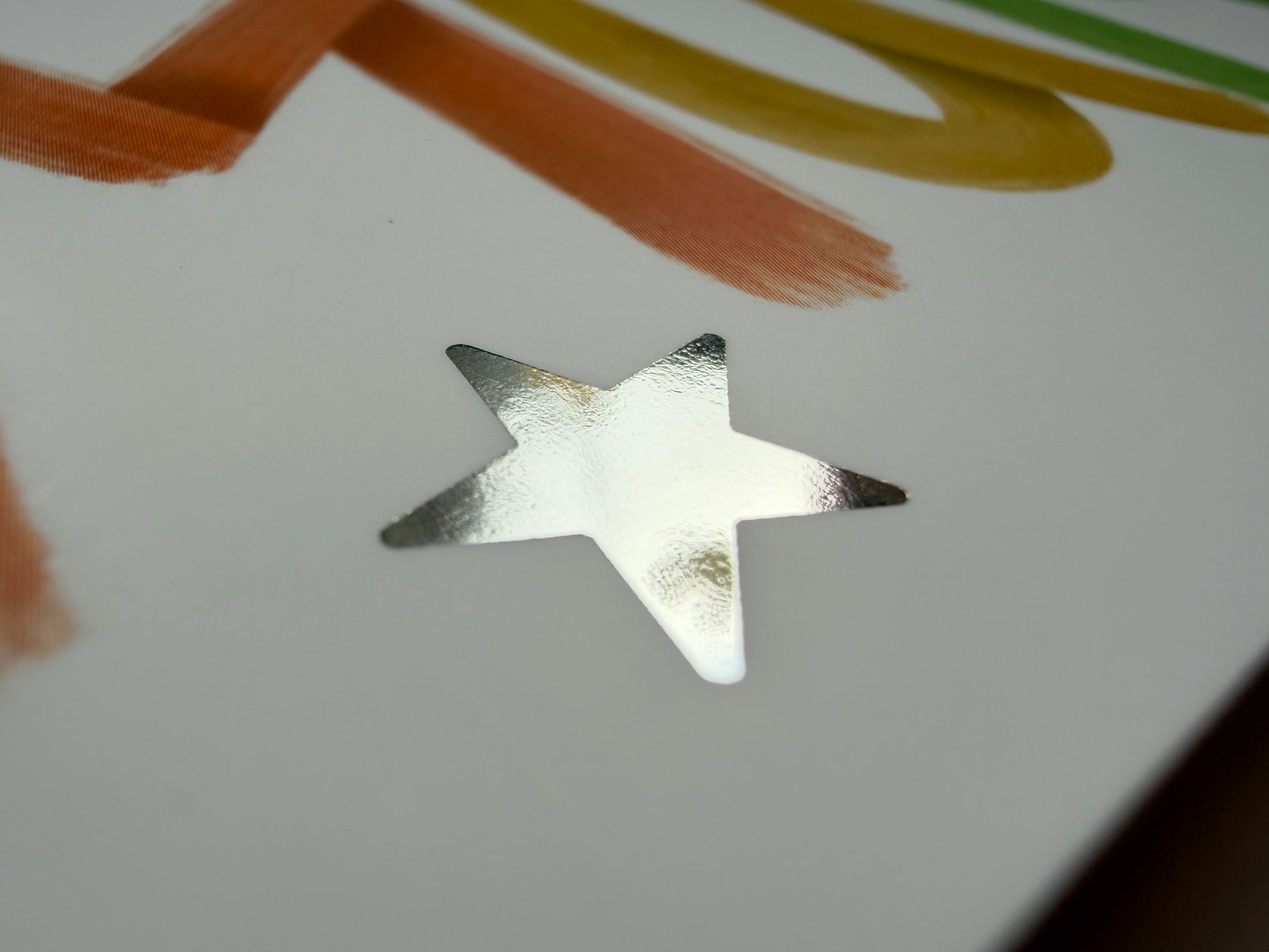 A close up of the silver foil star