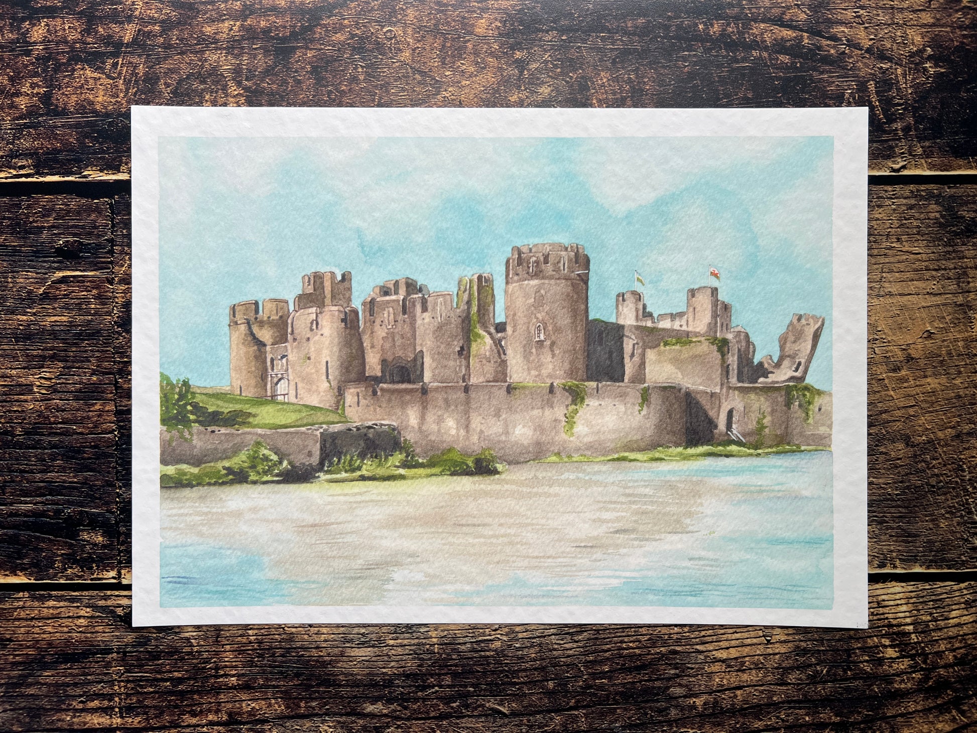 A photograph of a watercolour print depicting Caerphilly castle
