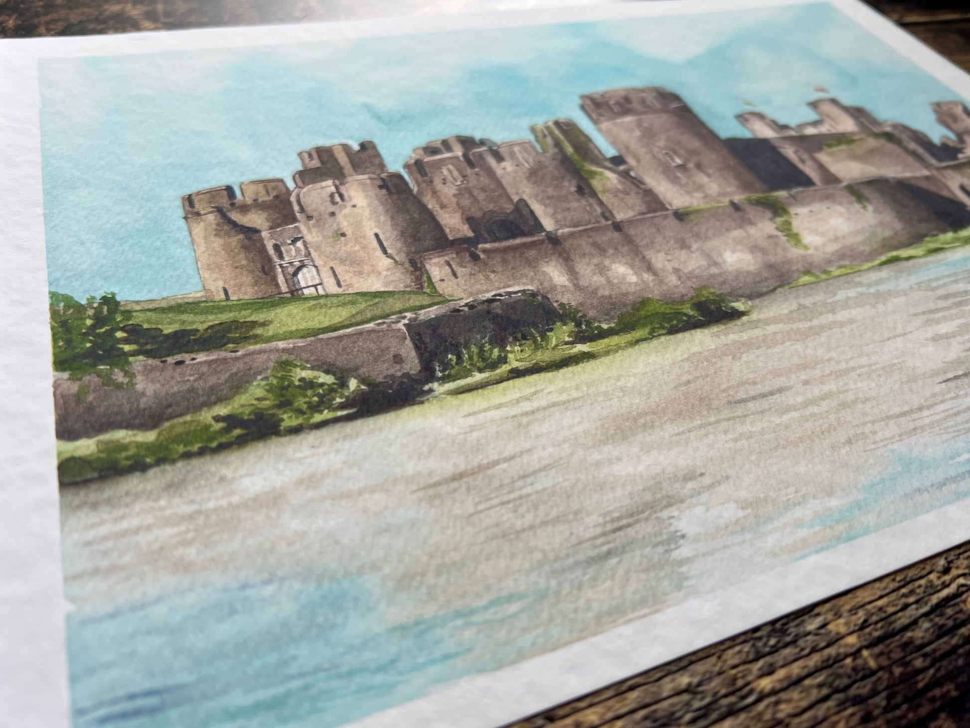 A photograph of a watercolour print depicting Caerphilly castle