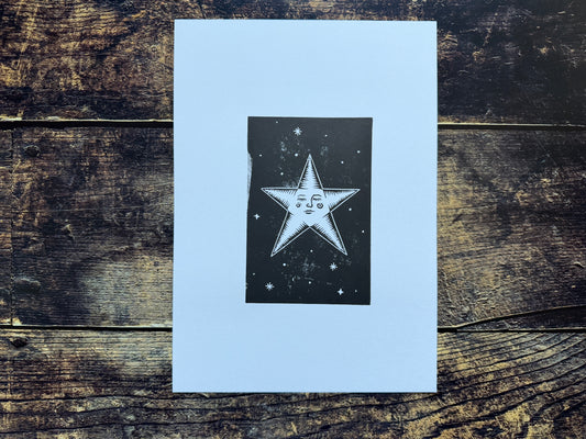 An A4 lino print of a star