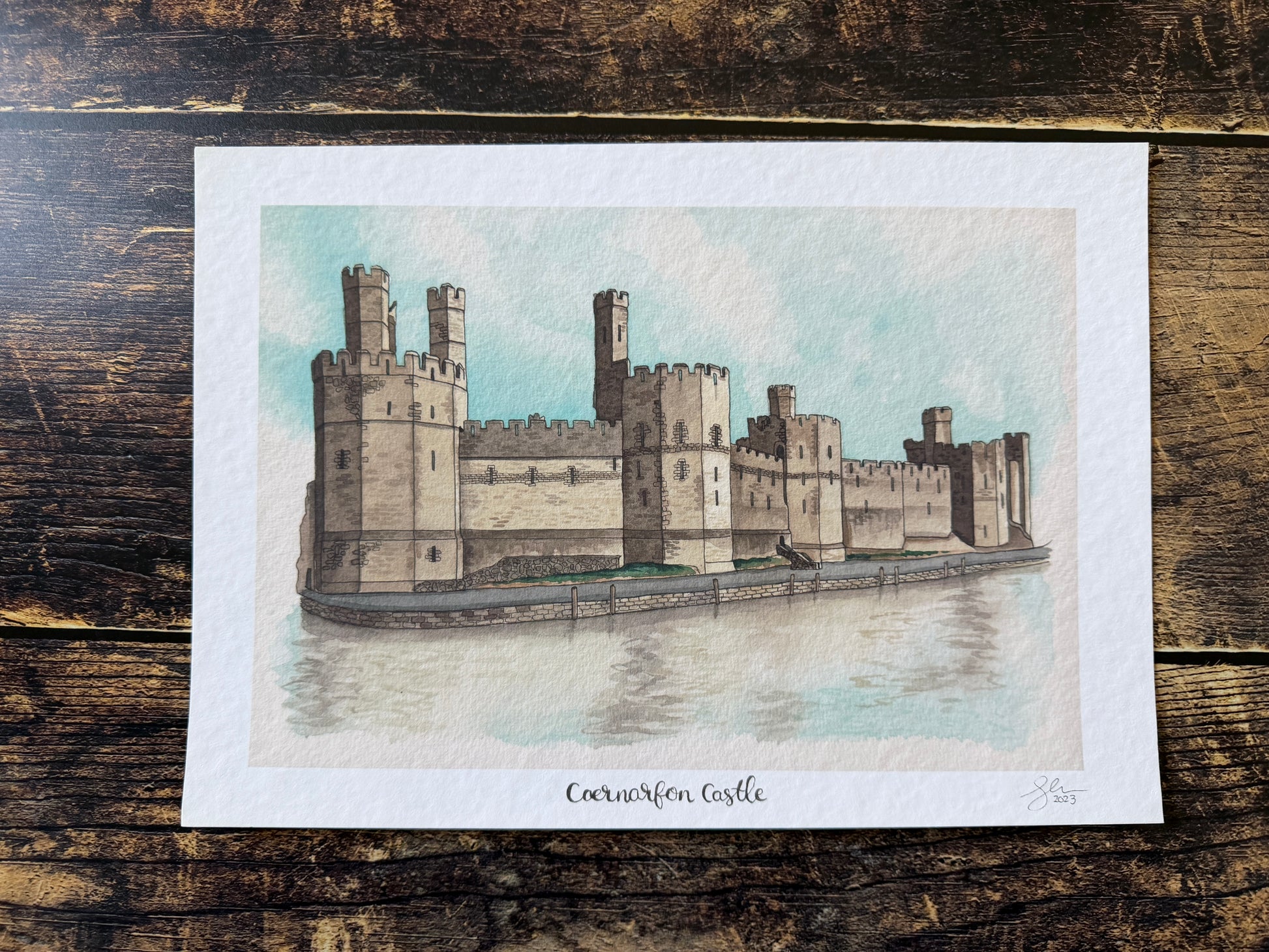 A watercolour print of Caernarfon Castle in North Wales