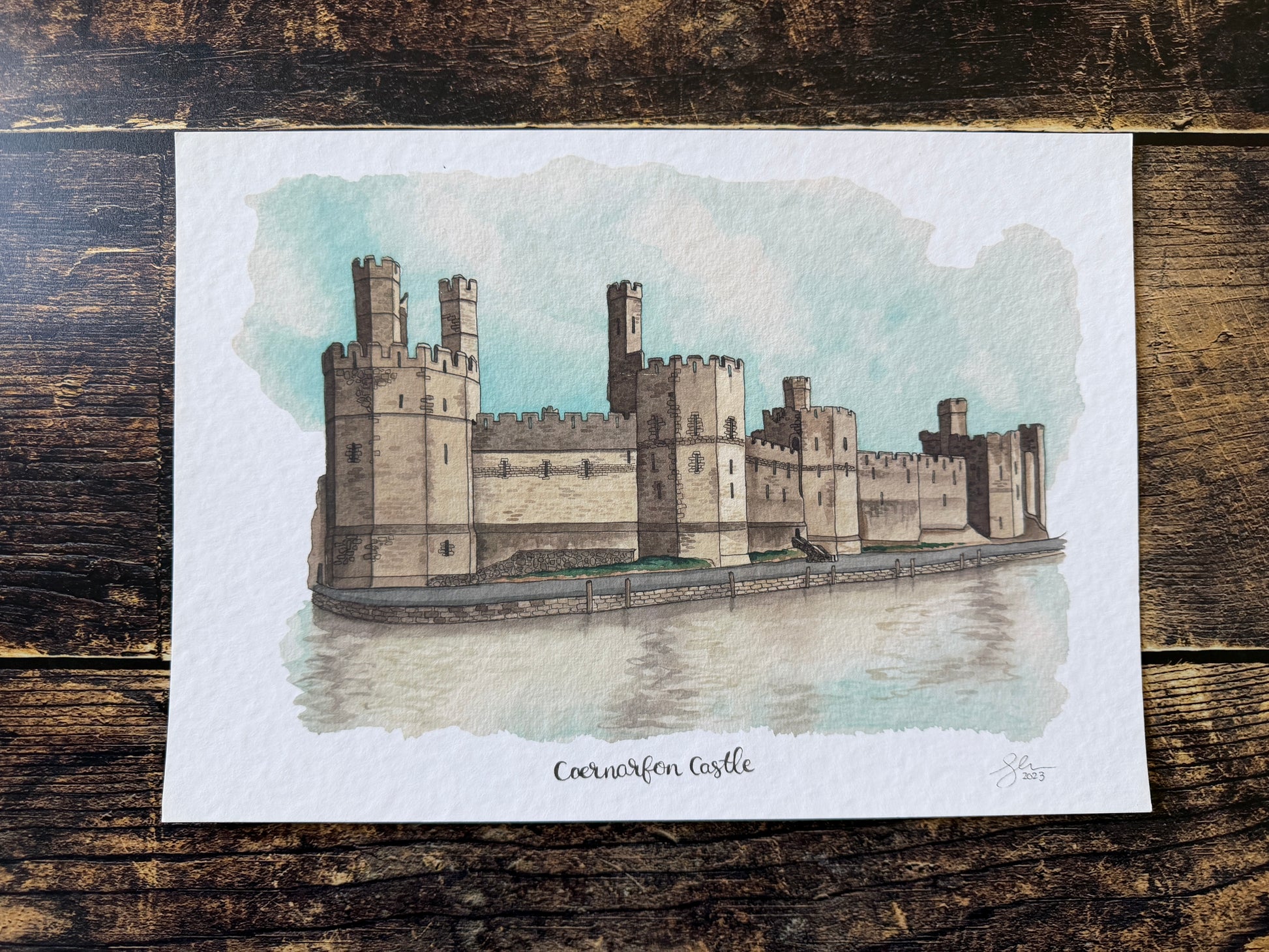 A watercolour print of Caernarfon Castle in North Wales