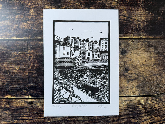 An A4 black  white lino print of Tenby Harbour
