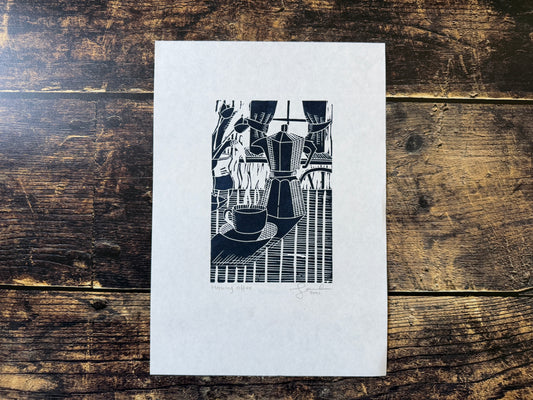 A lino print of a coffee and moka pot on a dining table