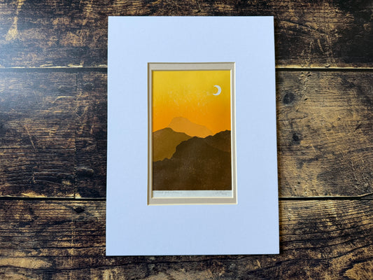 A multiblock lino print of mountains at sunset