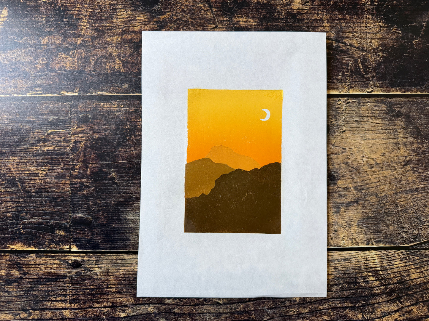 A multiblock lino print of mountains at sunset