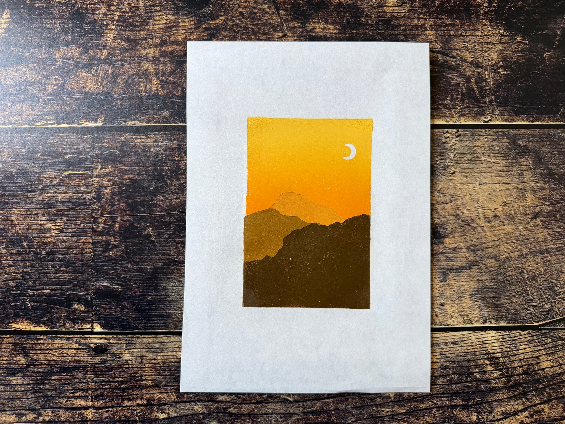 A multiblock lino print of mountains at sunset