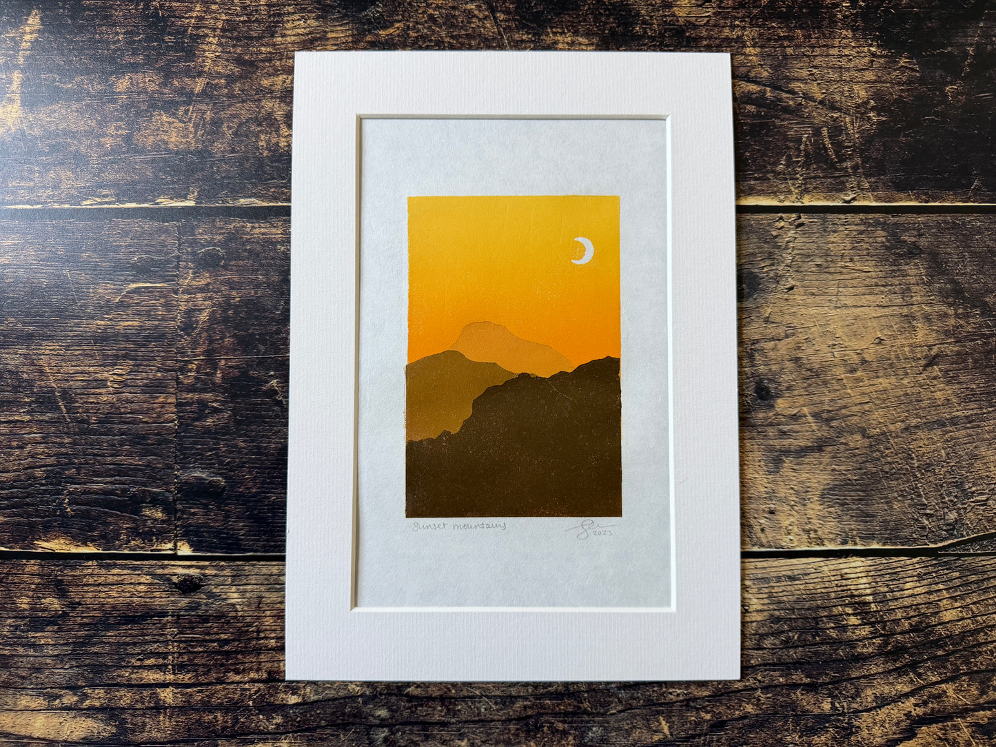 A multiblock lino print of mountains at sunset