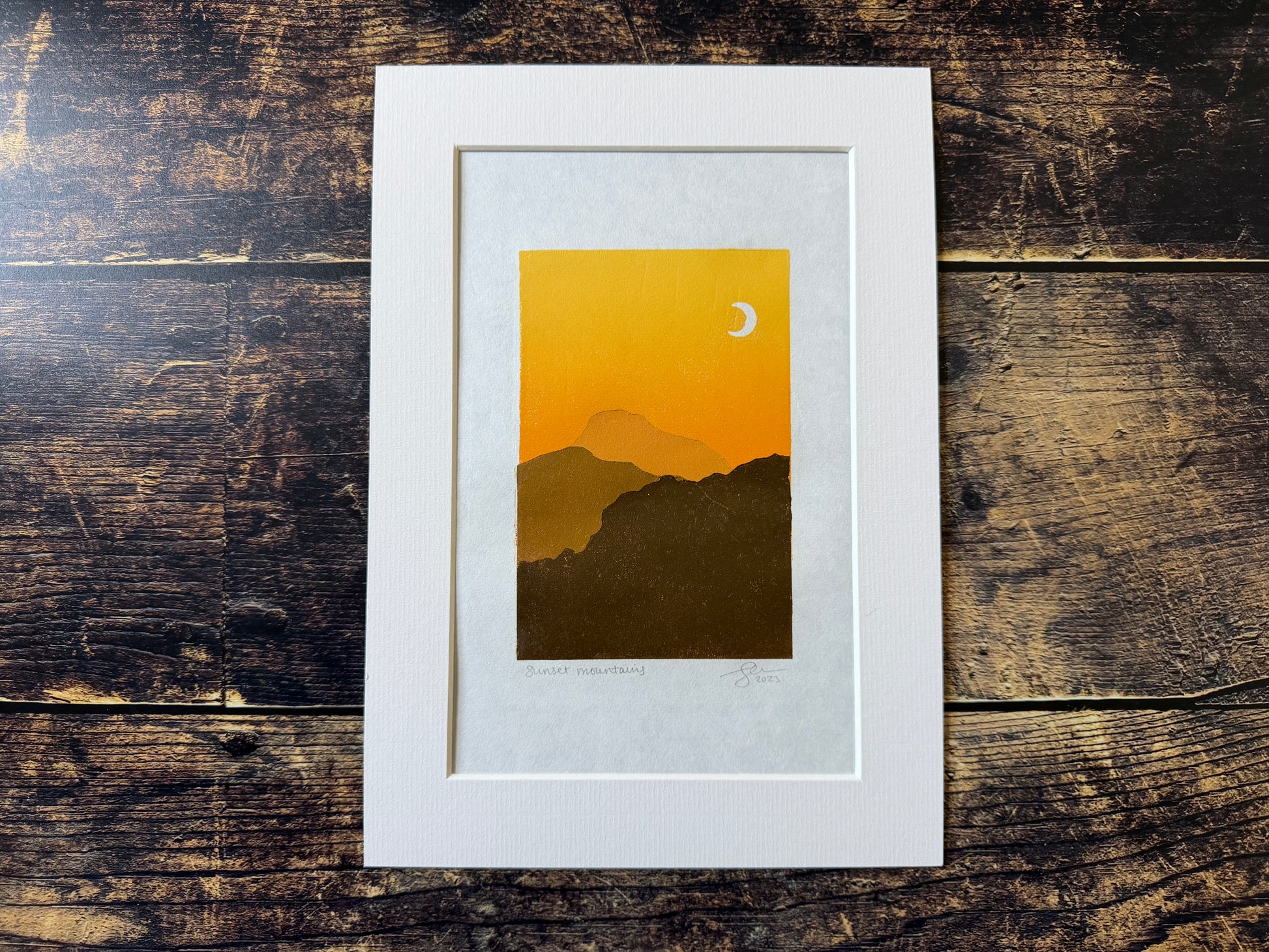 A multiblock lino print of mountains at sunset