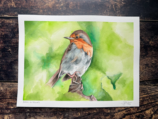 Watercolor painting of a bird on a green background, displayed on a wooden surface.