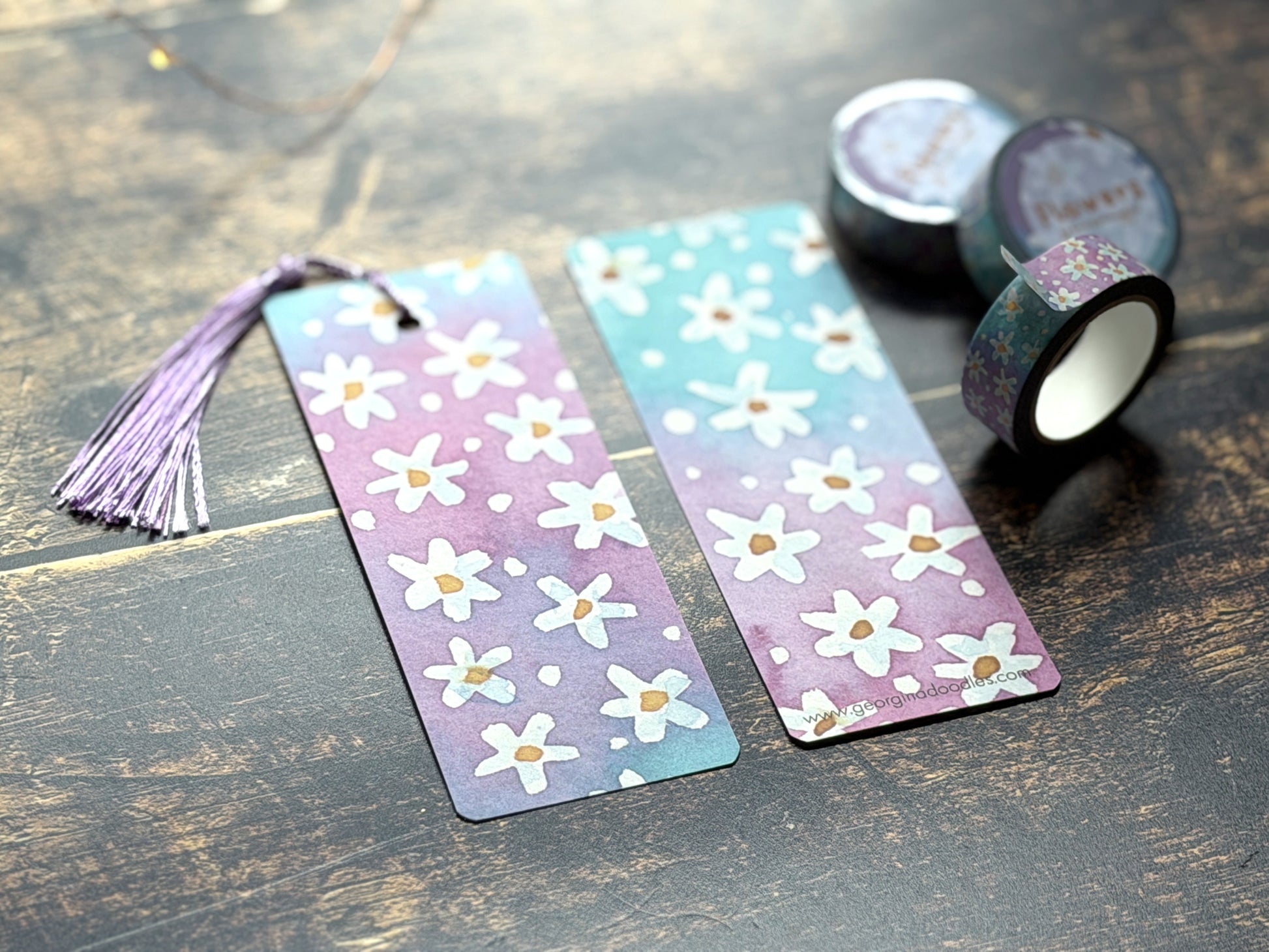 A photo of watercolour floral bookmarks on a wooden background
