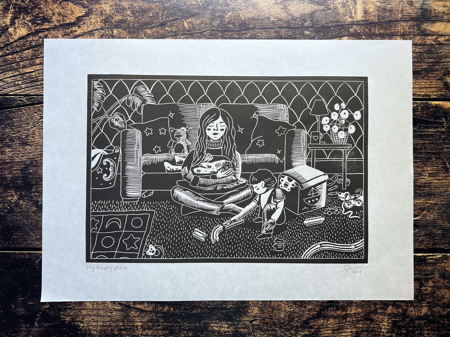 A lino print depicting a mum of two young children, and the chaos that surrounds her.