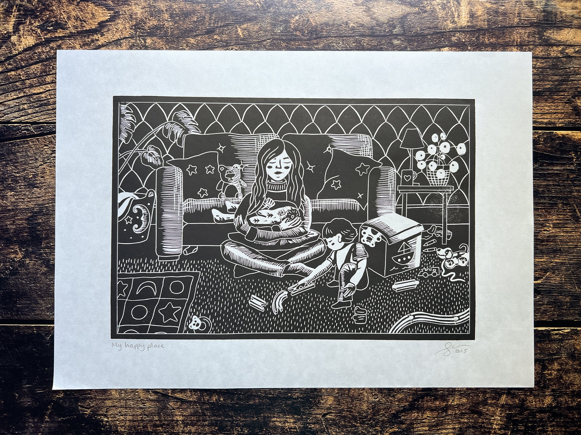 A lino print depicting a mum of two young children, and the chaos that surrounds her.