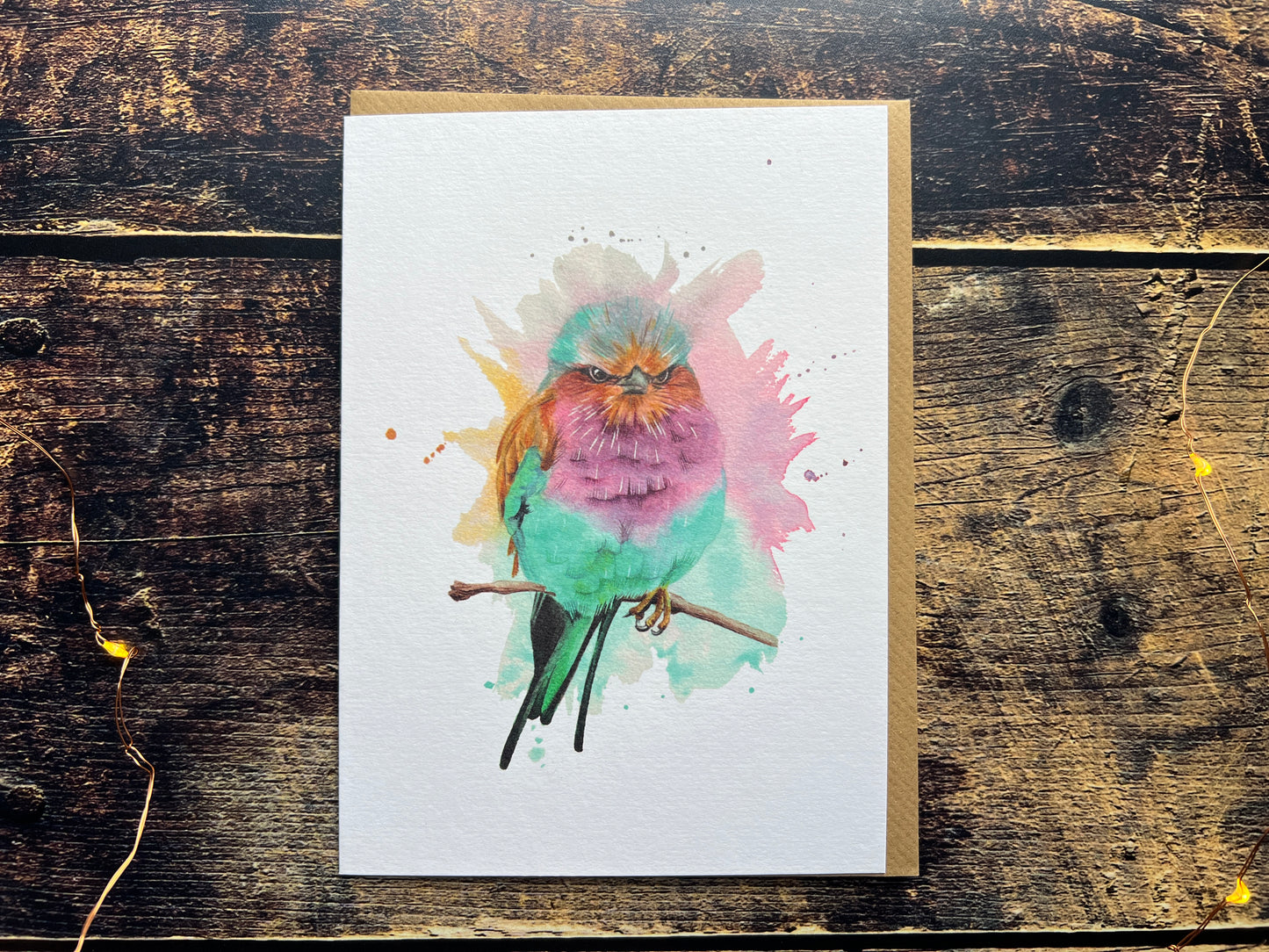 A blank greetings card with a watercolour painting of a lilac-breasted roller on the front.