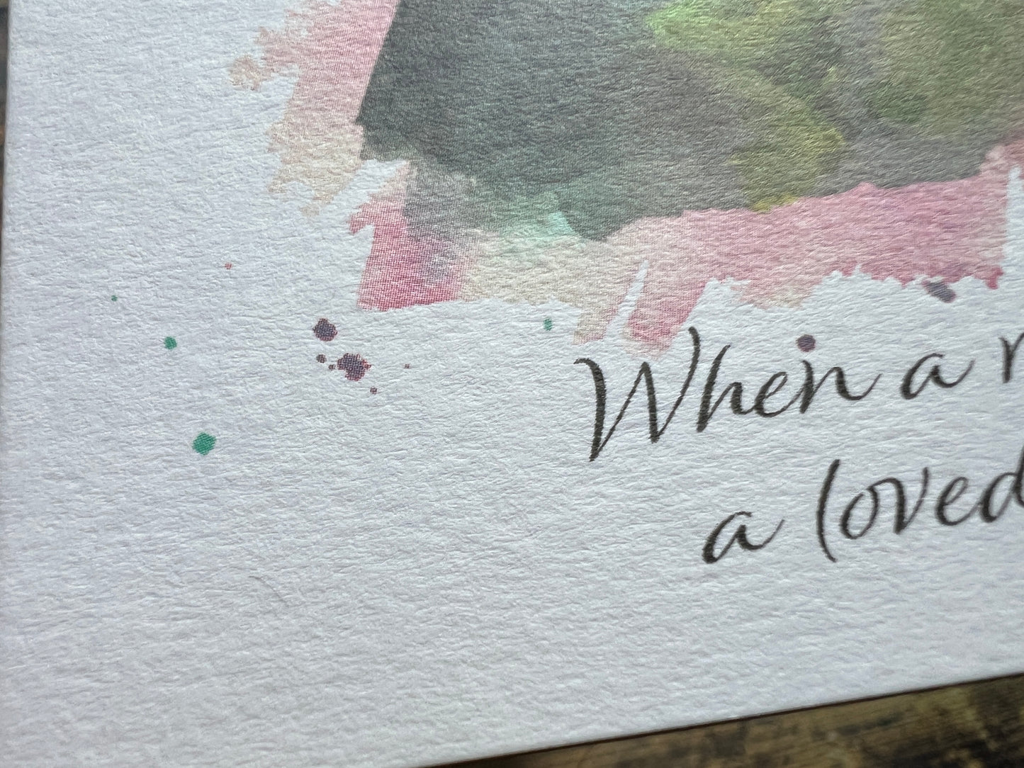 Text on a textured surface with watercolor splashes