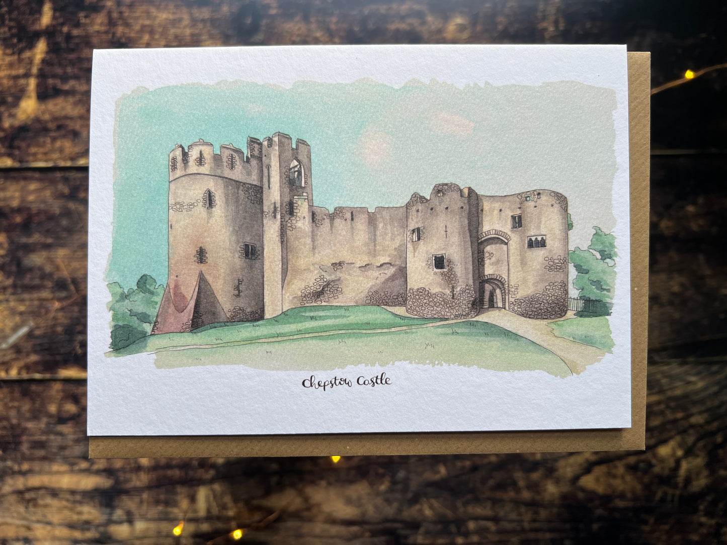 A photo of a card featuring my watercolour of chepstow castle, with the text underneath 'chepstow castle'.