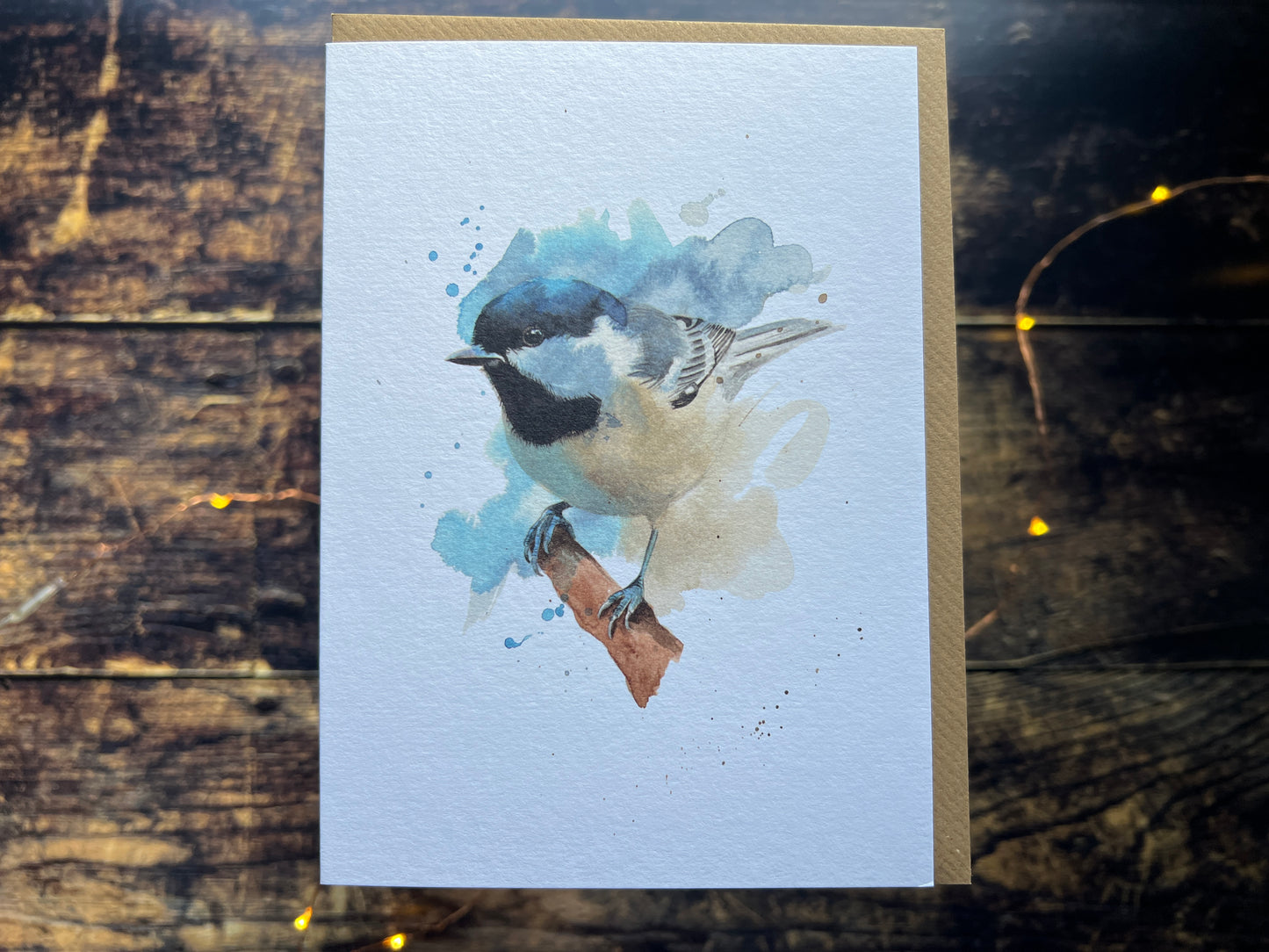 A photo of a greetings card with a watercolour coal tit on the front