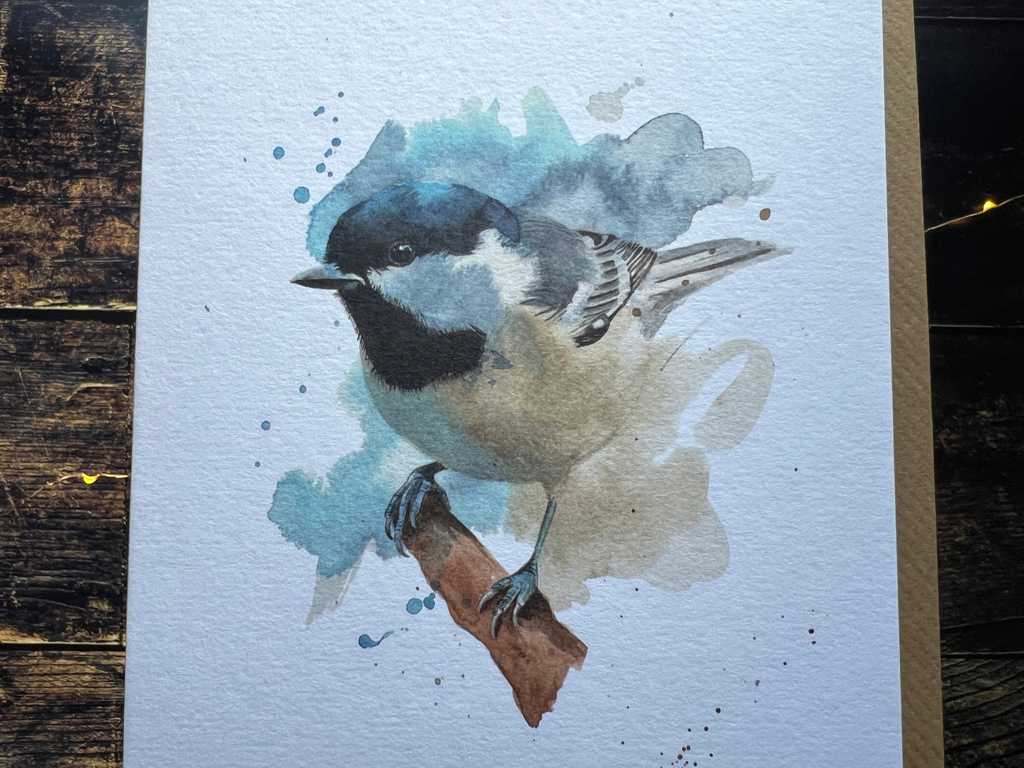 Watercolor painting of a coal tit on a textured surface