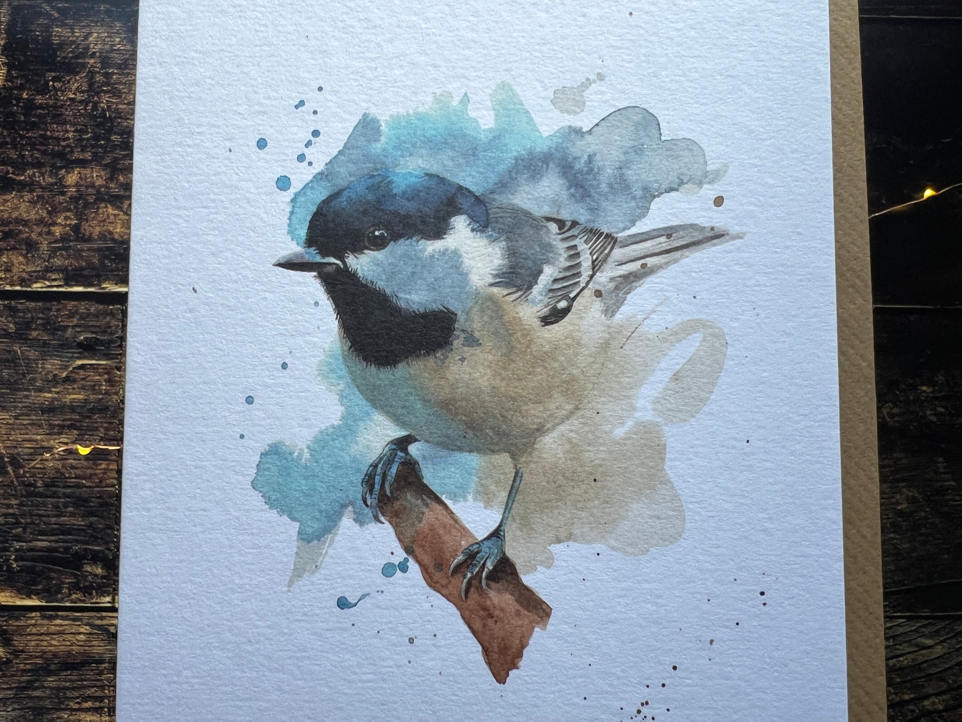 Watercolor painting of a coal tit on a textured surface