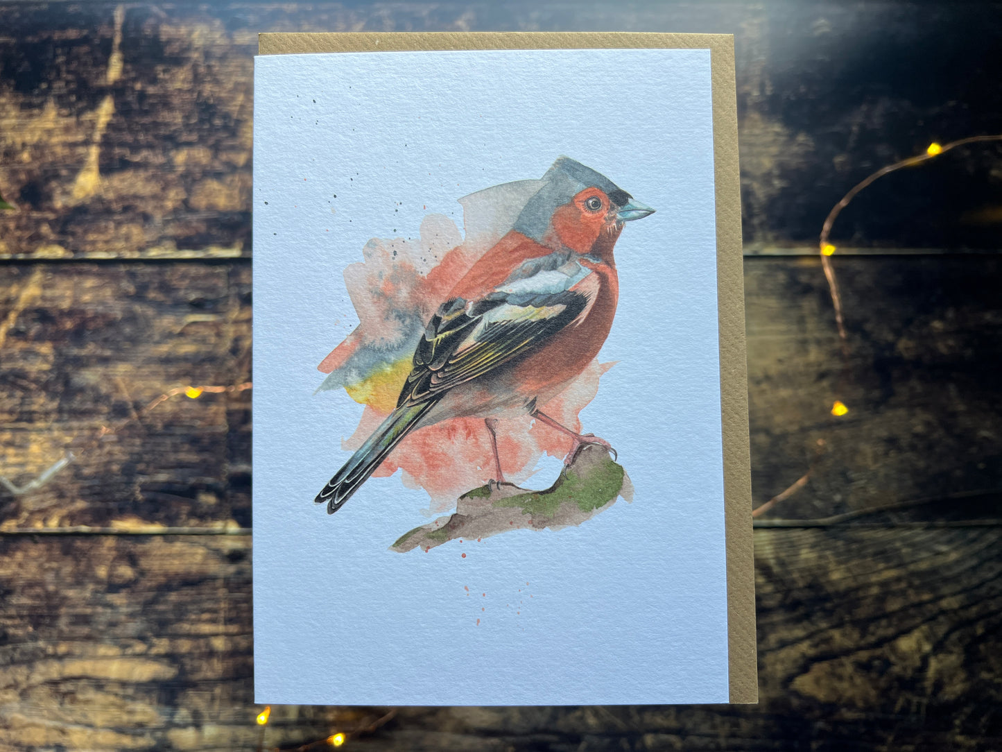 A greetings card with a watercolour chaffinch on the front.