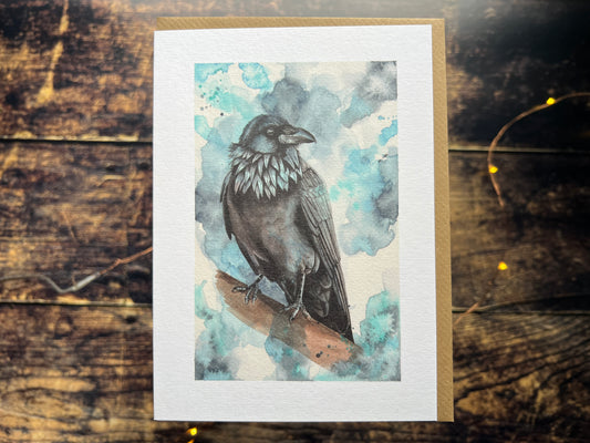A greetings card featuring a watercolour painting of a raven