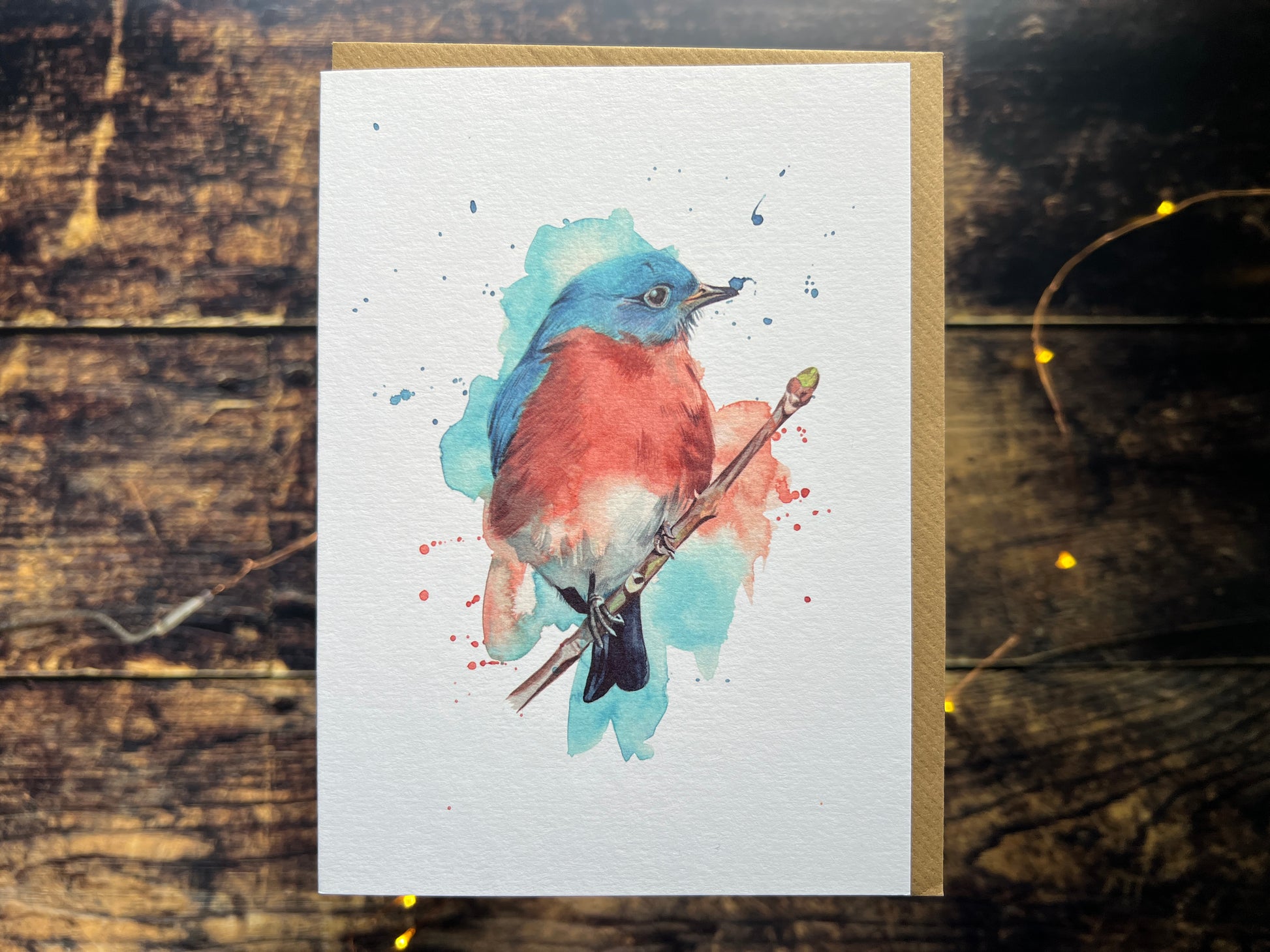 A photograph of a greetings card with a watercolour eastern bluebird on the front