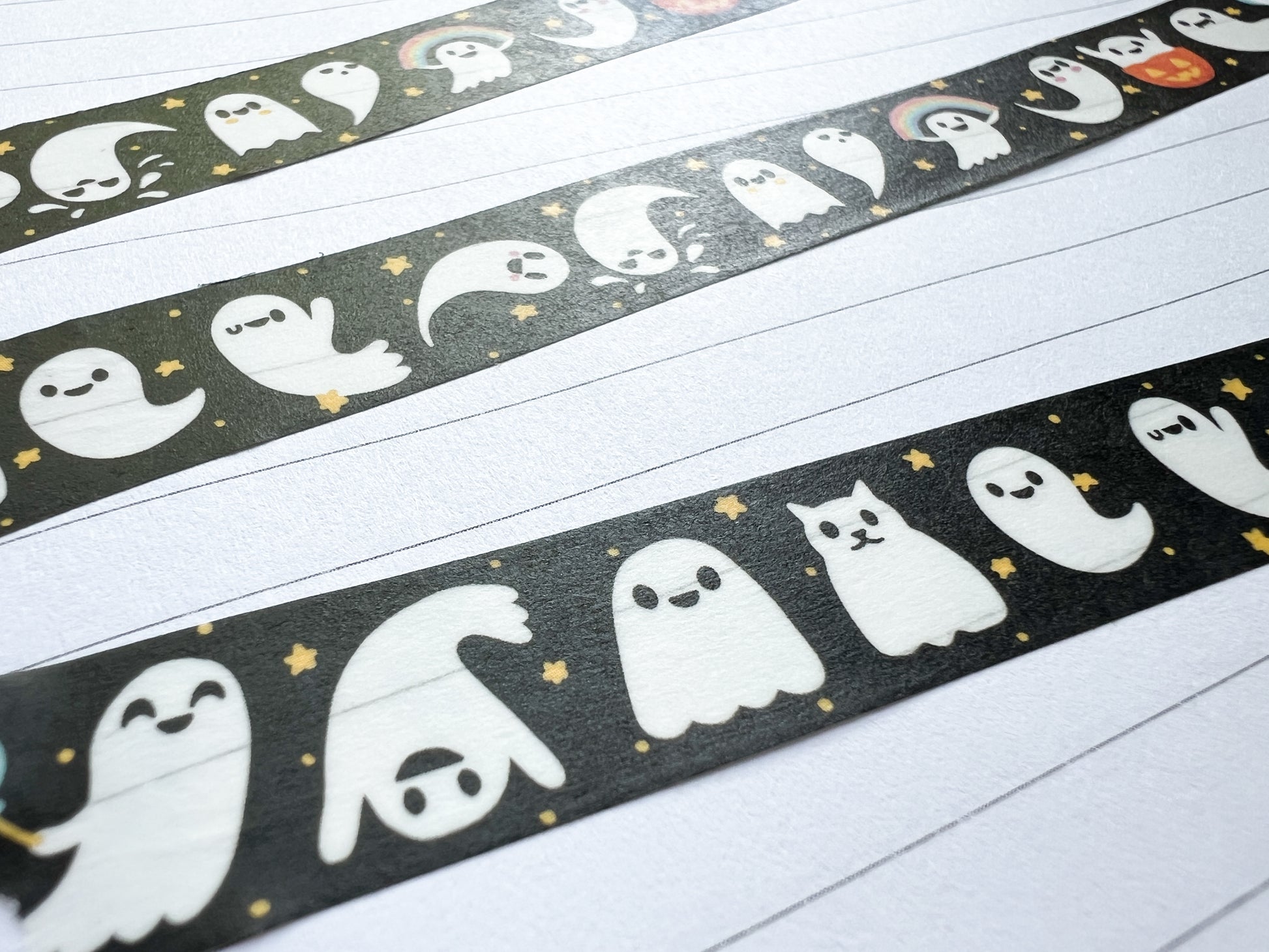 Decorative washi tape with ghost design, stuck in a journal