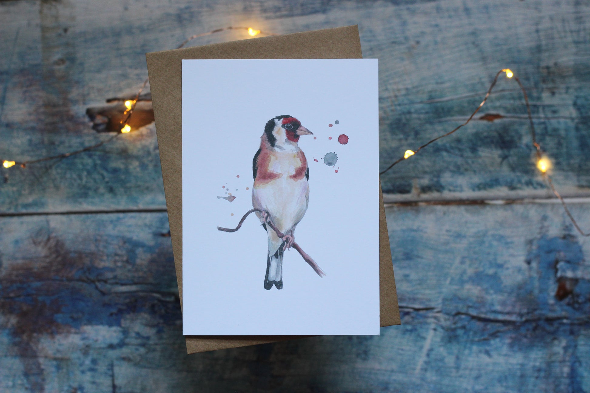 An A6 card and brown kraft envelope featuring a goldfinch
