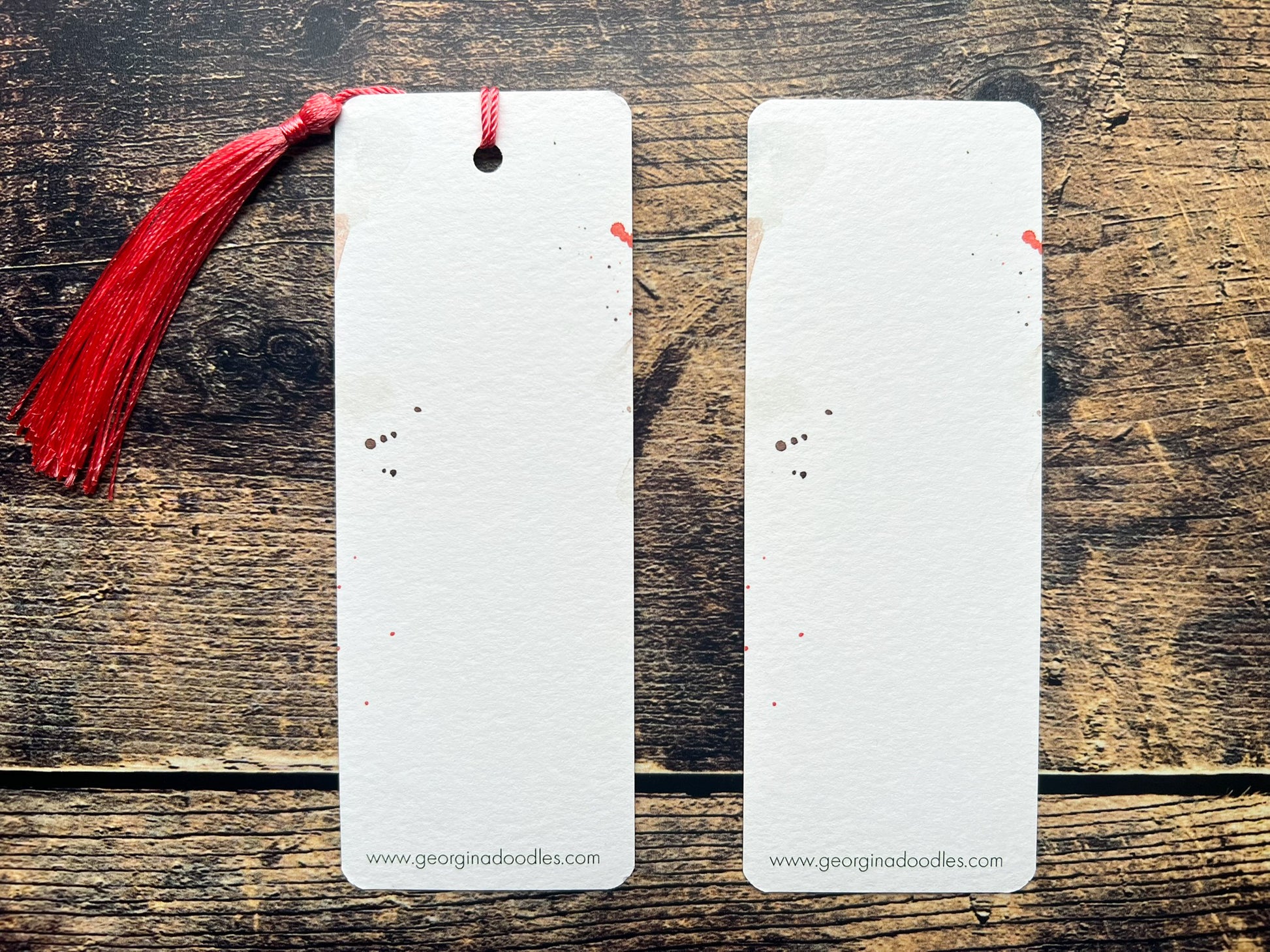 A photo of the back of a bookmark of a great spotted woodpecker watercolour