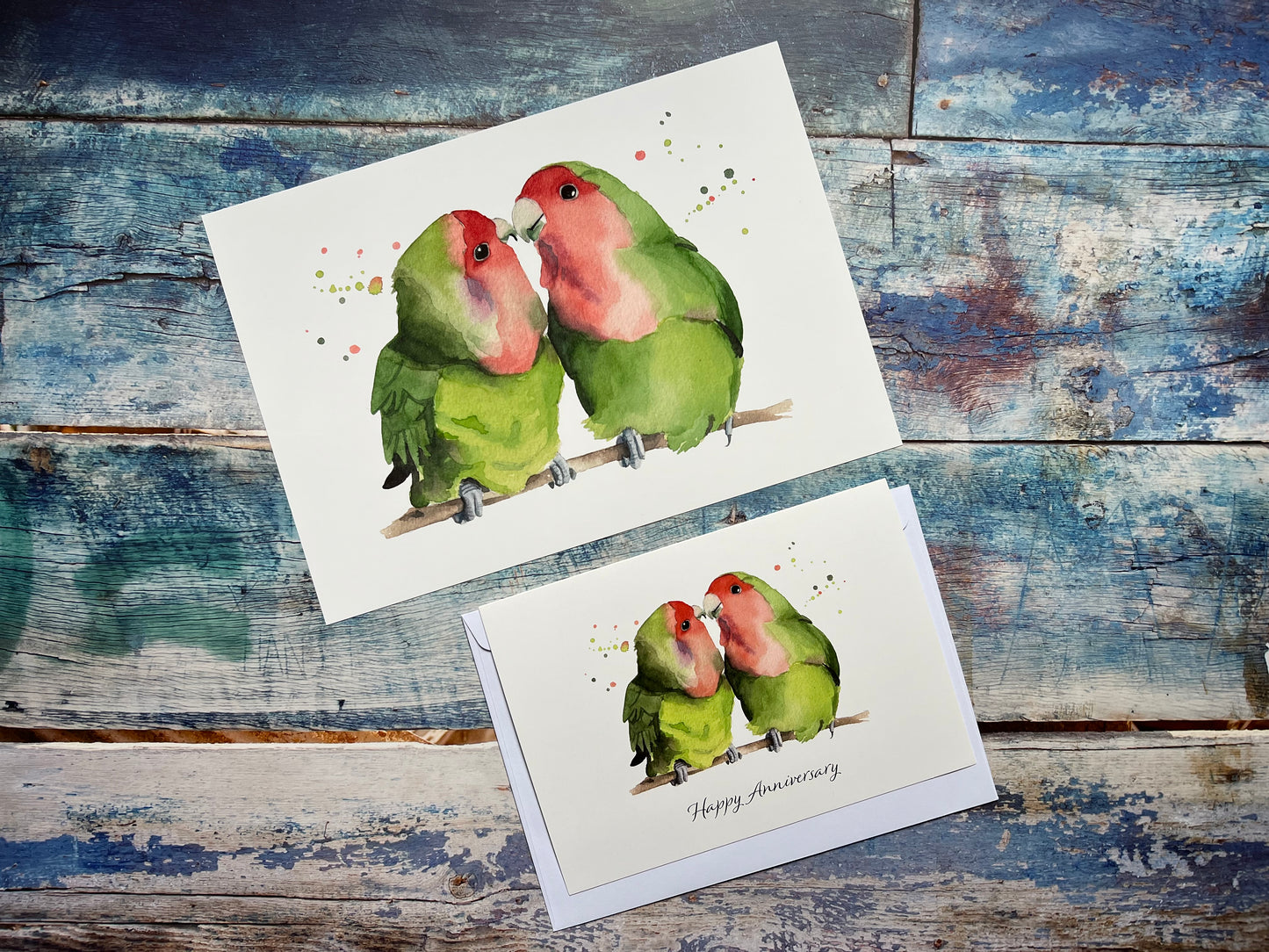 A photo of a watercolour lovebirds art print and anniversary card