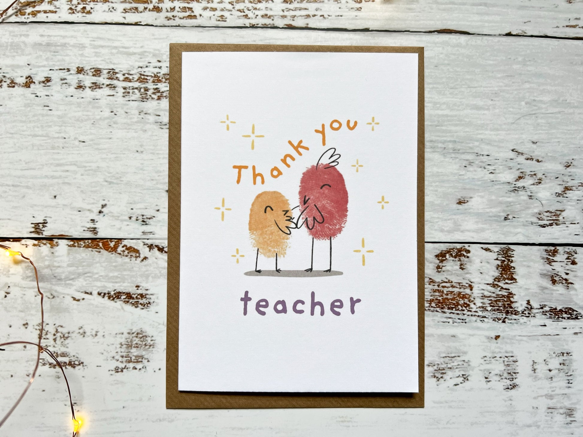 An A6 card reading thank you teacher, that has two finger printed birds on the front.